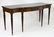 An early 20thC mahogany sideboard with a shaped top, a