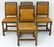 A set of four oak Arts and Crafts style dining chairs