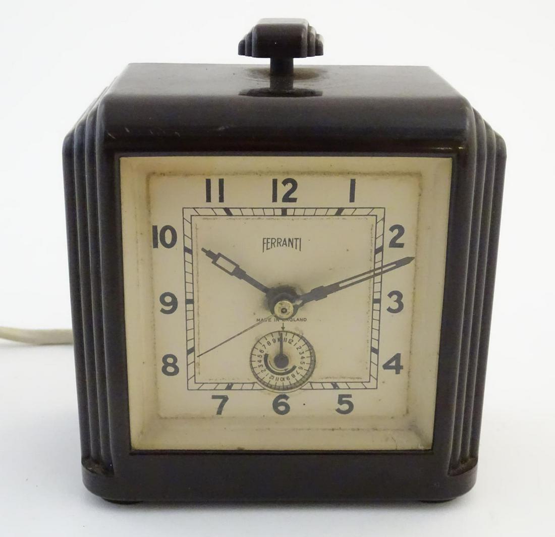 Clocks: an early-to-mid 20thC Art Deco electric alarm: Clocks: an early-to-mid 20thC Art Deco electric alarm clock by Ferranti, England, with bakelite case, the back stamped 'Patent no. 384681', 4 1/4" tall