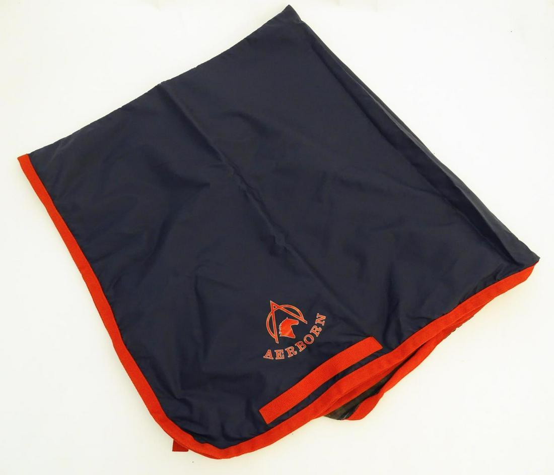 A lined waterproof horse exercise sheet in navy and: A lined waterproof horse exercise sheet in navy and red, approx. 4' Condition Report Please Note - we do not make reference to the condition of lots within descriptions. We are however happy to provid