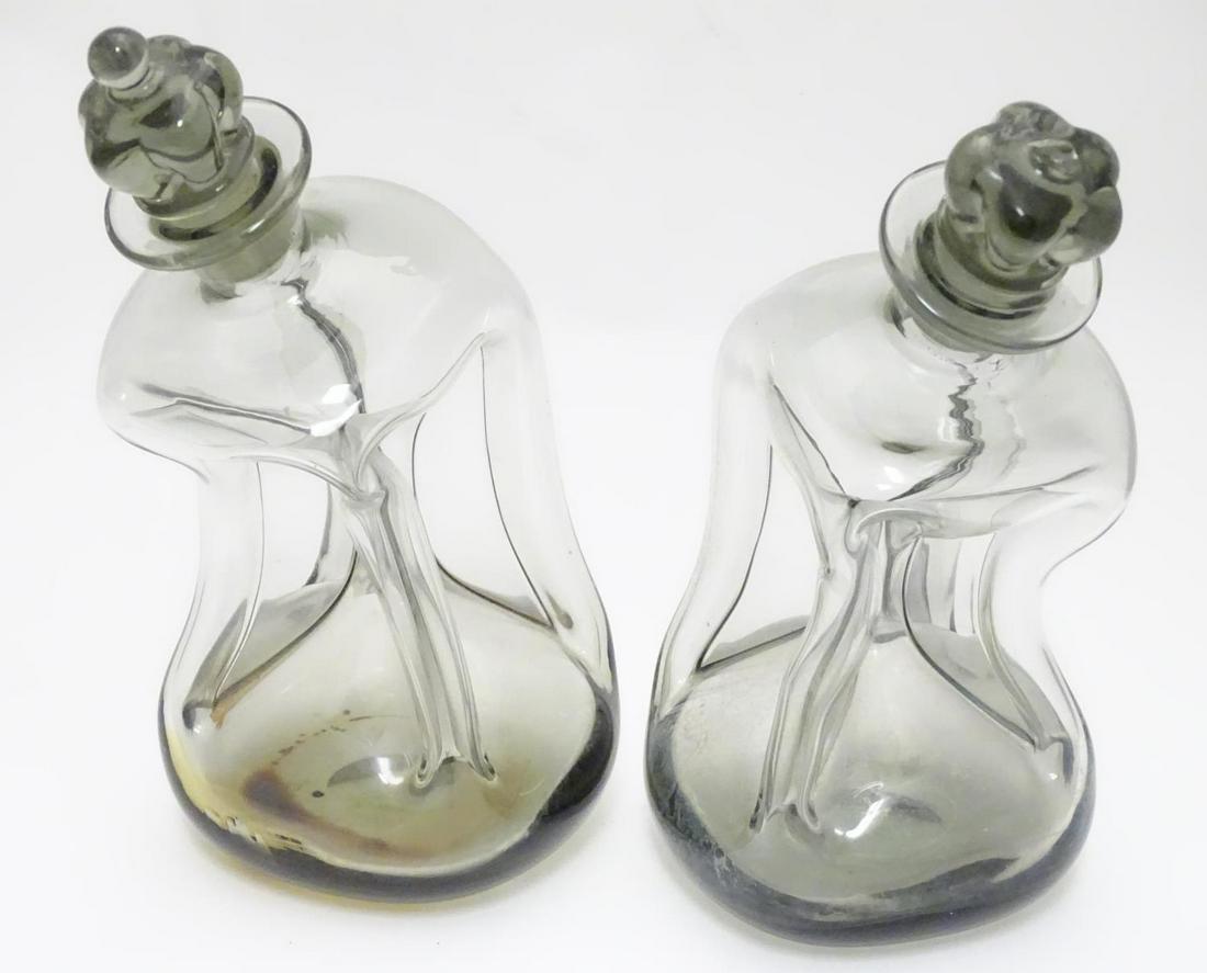 Two 20thC Danish smoked glass decanters with pinch: Two 20thC Danish smoked glass decanters with pinch detail by Holmegaard, each approximately 9" tall (2)