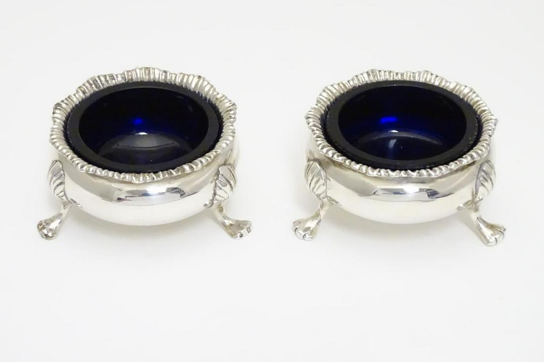 A pair of Victorian silver table salts with blue glass: A pair of Victorian silver table salts with blue glass liners. Hallmarked London 1892 maker Charles Stuart Harris. Approx. 2 1/4" diameter