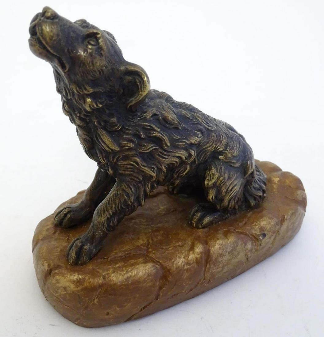 A late 19th / early 20thC cast model of a seated dog: A late 19th / early 20thC cast model of a seated dog mounted upon a base. Approx. 5 1/2" high