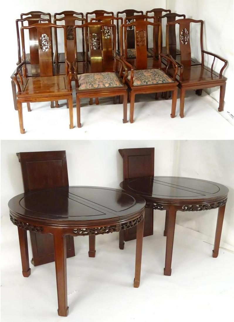 An early 20thC set of twelve dining chairs together: An early 20thC set of twelve dining chairs together with a matching dining table. The Chinese hardwood dining table with two additional leaves and a carved surround. The chairs having shaped top rails
