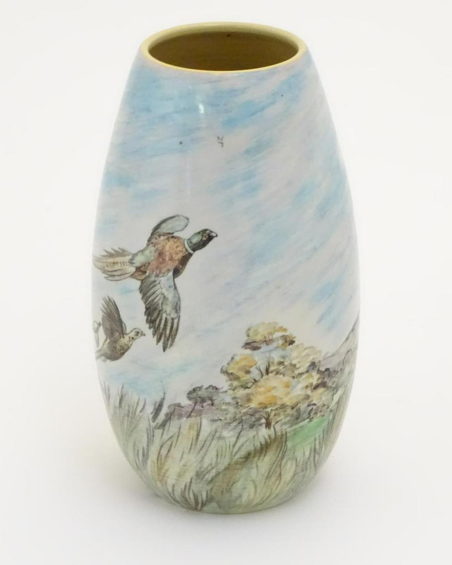 A Branksome vase of ovoid form with hand painted: A Branksome vase of ovoid form with hand painted decoration depicting a landscape scene with a stag and pheasants in flight. Marked and signed under J. R. Hare. Approx. 7 3/4" high