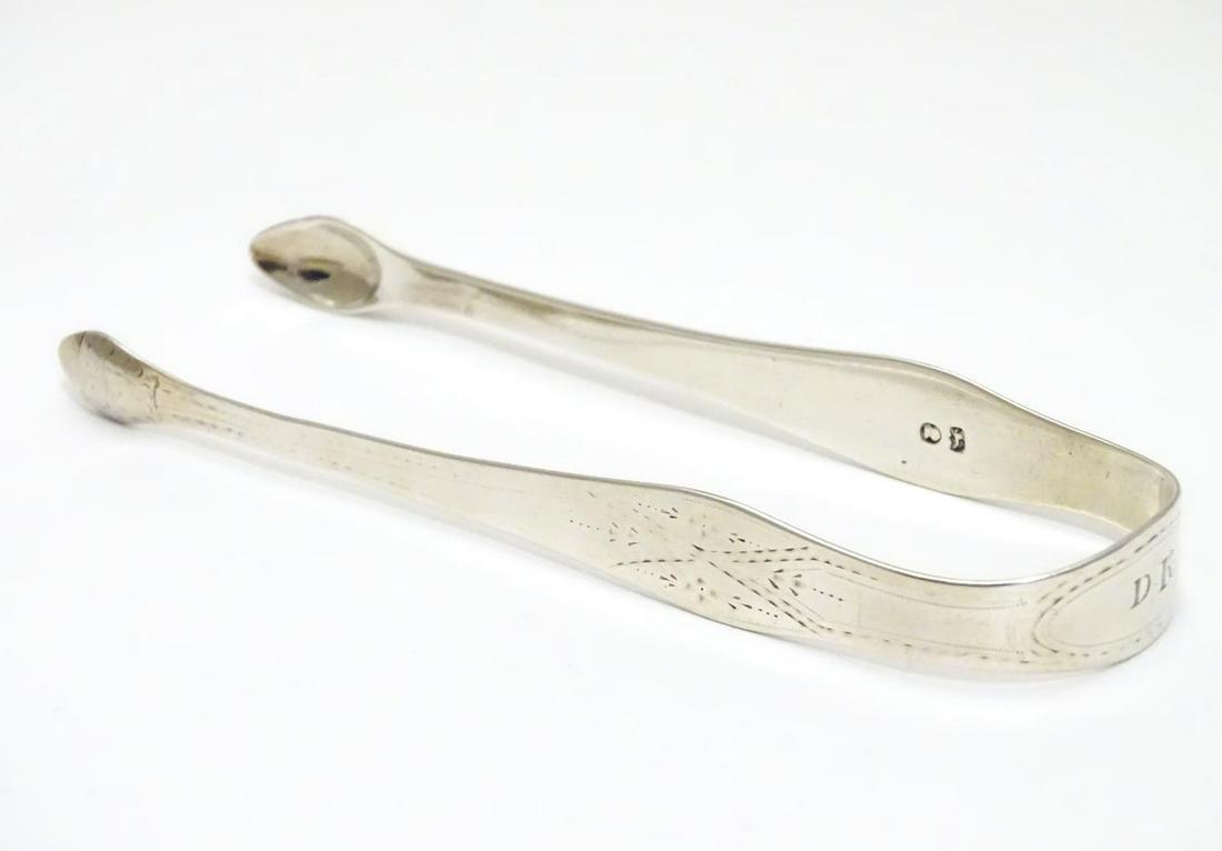 Geo III silver sugar tongs with bright cut decoration.: Geo III silver sugar tongs with bright cut decoration. Maker Hester Bateman. Late 18thC . Approx 5 1/2" long