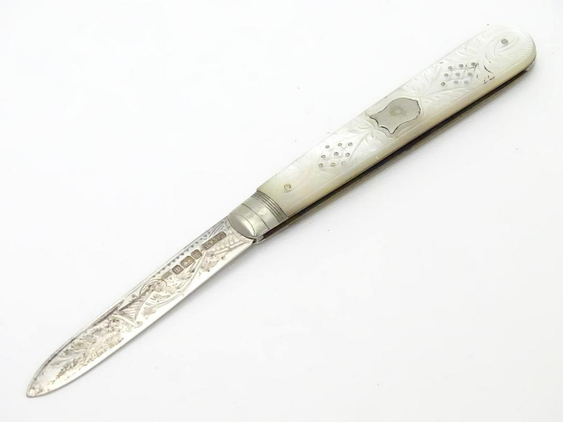 A silver folding fruit knife with mother of pearl: A silver folding fruit knife with mother of pearl handle having engraved decoration. Hallmarked Sheffield 1902 maker Henry Williamson Ltd. 5 1/2" long (open)
