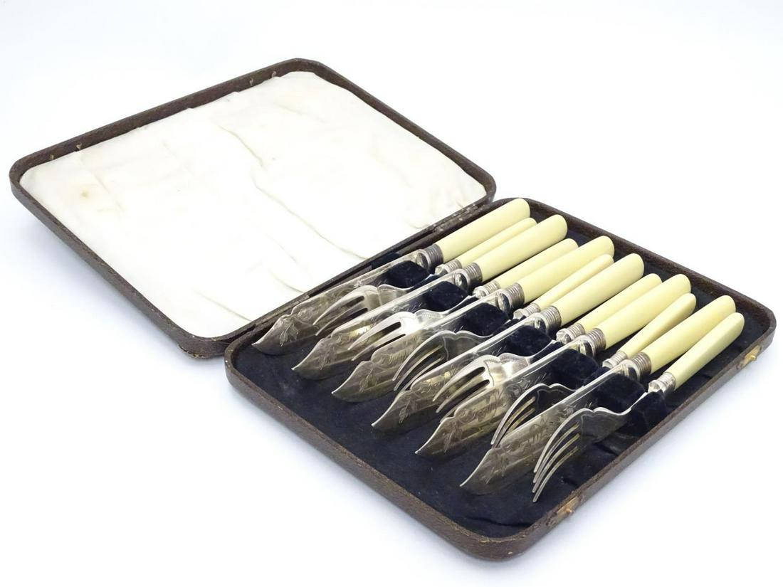 A cased set of fish knives and forks (6+6), each with: A cased set of fish knives and forks (6+6), each with silver collar hallmarked Sheffield 1926 maker William Yates Ltd.