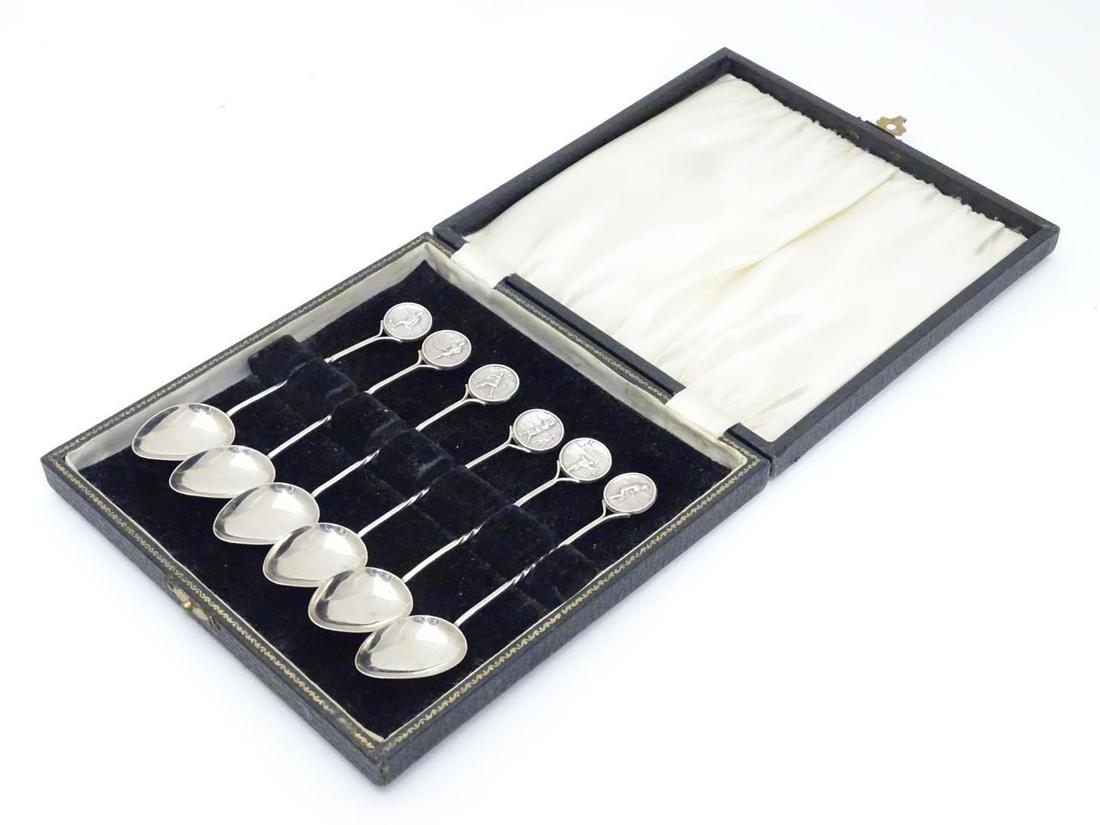 A set of 6 silver spoons the handles surmounted by: A set of 6 silver spoons the handles surmounted by roundels depicting various sporting activities including cricket, golf, football, bowl, tennis and hockey. Hallmarked Birmingham 1929 maker RB. Each 