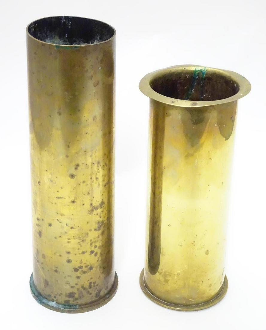 Militaria : two brass artillery shell/cartridge cases,: Militaria : two brass artillery shell/cartridge cases, with headstamps for 1917 (German 77mm, WWI) and 1943 (British 6pdr, WWII), the largest 10 1/2" tall