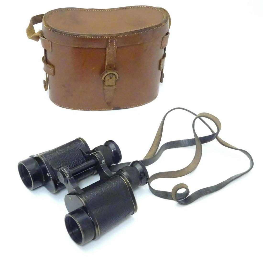 A cased pair of binoculars / Field Glasses by A.: A cased pair of binoculars / Field Glasses by A. Kershaw & Sons, Leeds, stamped 1941, approximately 5" long
