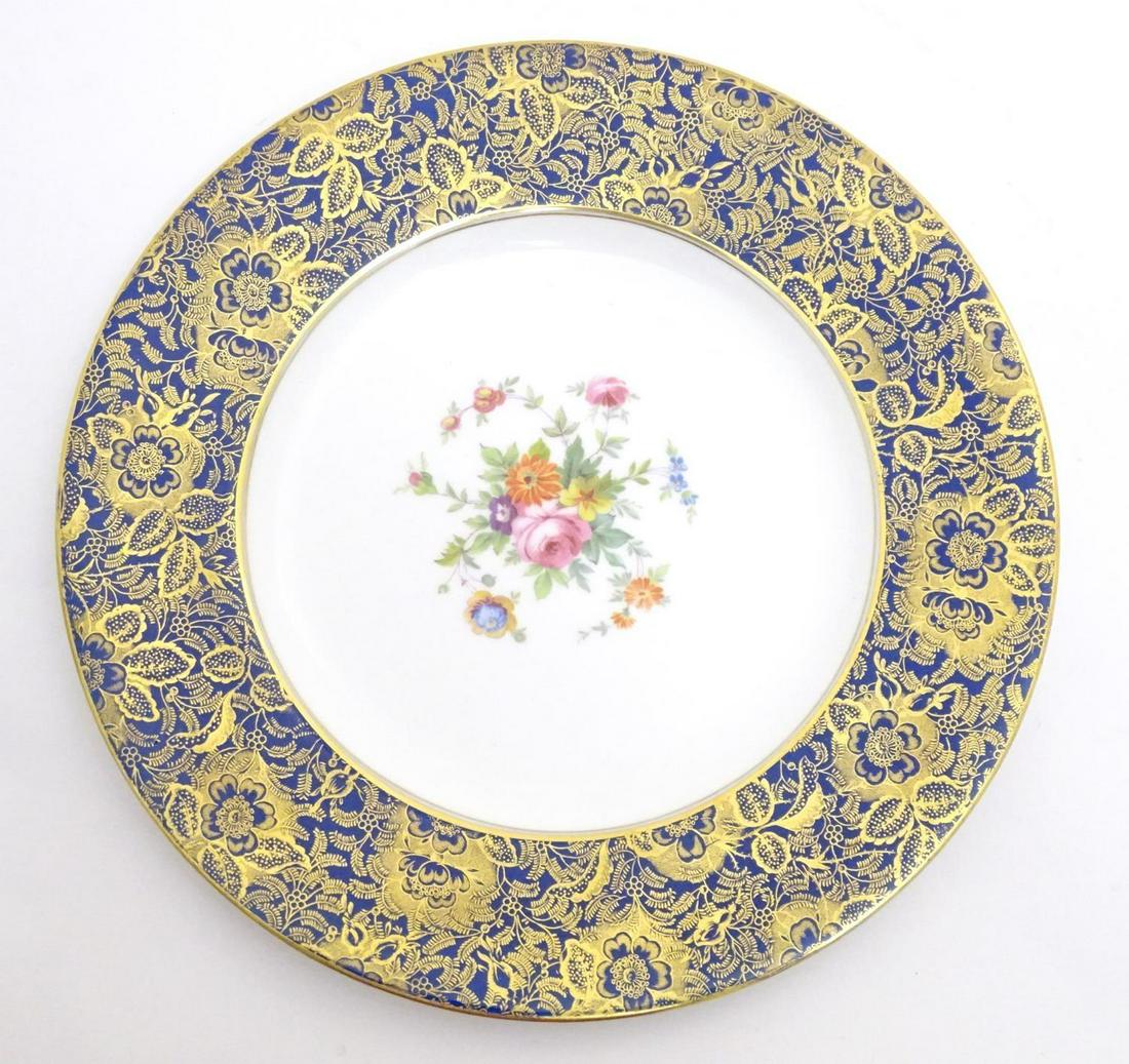 A Minton cabinet plate in the pattern Brocade with: A Minton cabinet plate in the pattern Brocade with central floral motif. The blue border with gilt floral and foliate detail. Marked under and impressed Minton China 7-60. Approx. 10 1/2" diameter