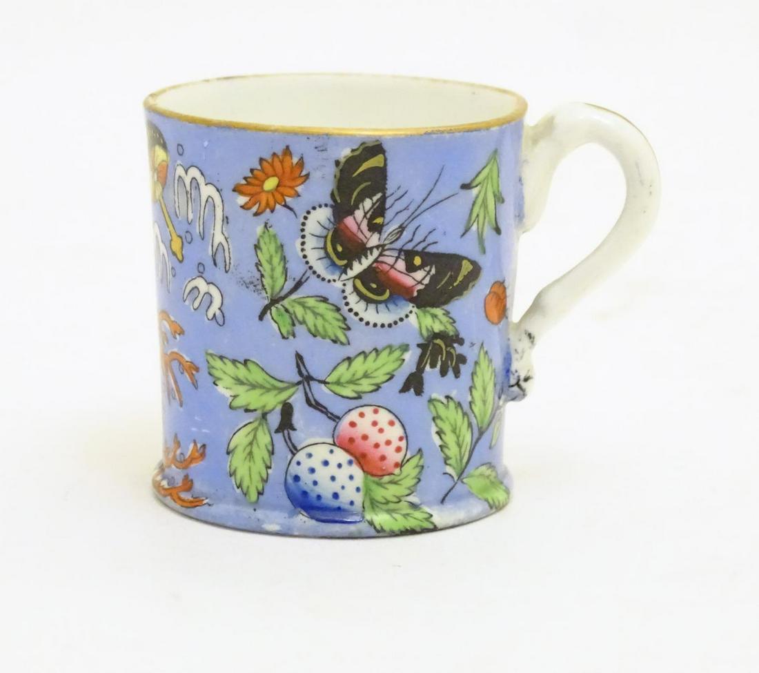 A 19thC coffee cup with hand painted decoration: A 19thC coffee cup with hand painted decoration depicting butterflies, strawberries and foliage. Approx. 1 3/4" high