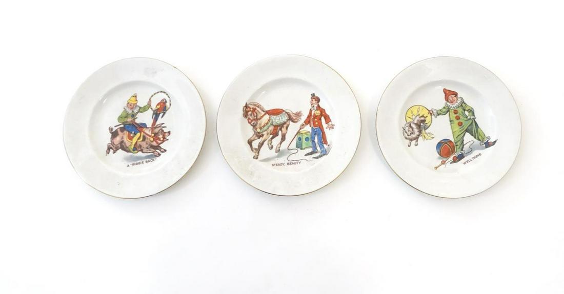 Three Morley, Fox & Co. children's circus plates,: Three Morley, Fox & Co. children's circus plates, comprising, A Piggie Back, with a circus figure riding a pig carrying a parrot in a hoop, Well Done, depicting a dog jumping through a hoop held by a