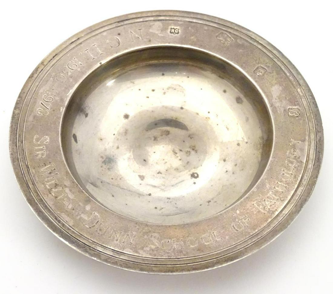 A small dish formed as armada dish and engraved 'NGH: A small dish formed as armada dish and engraved 'NGH 1936-1978 Sir William Dunn School of Pathology', and hallmarked London 1976 maker William Comyns & Sons Ltd. 4 1/4" diameter