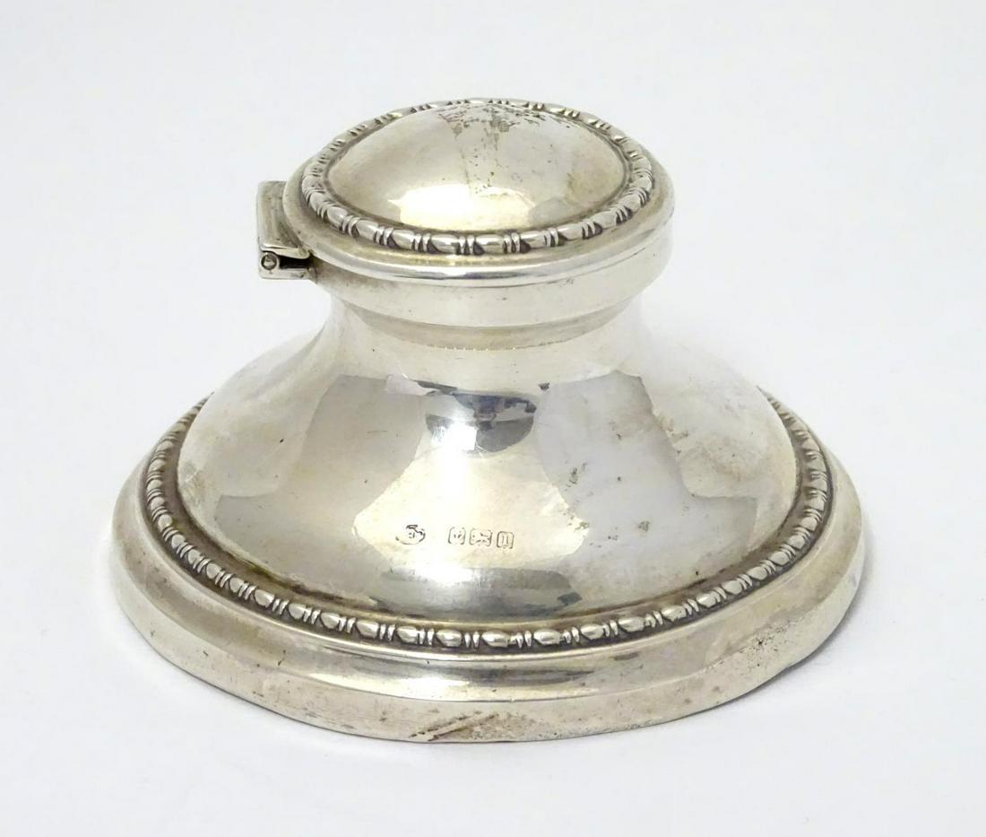 A silver inkwell of capstan form, hallmarked Birmingham: A silver inkwell of capstan form, hallmarked Birmingham 1910 maker William Hutton & Sons. 3 1/4" diameter