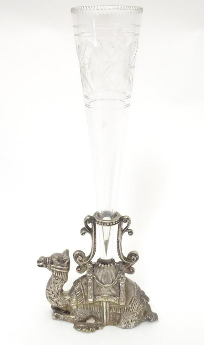 A Victorian silver plate epergne, the base formed as a: A Victorian silver plate epergne, the base formed as a recumbent camel with clear glass flute to centre. Marked with registration diamond under. 8 3/4" high overall.