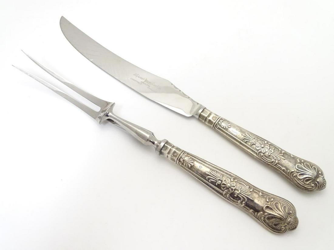 A silver handled Kings Pattern carving knife and fork.: A silver handled Kings Pattern carving knife and fork. Hallmarked Sheffield 1970 maker Harrison Brothers. Knife approx. 11 1/2" long.