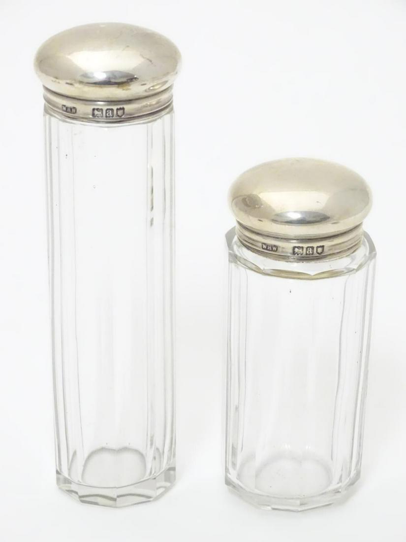 Two silver lidded glass dressing table / vanity: Two silver lidded glass dressing table / vanity bottles. Both hallmarked London 1896 maker WHW. Largest approx. 5 ¼?.