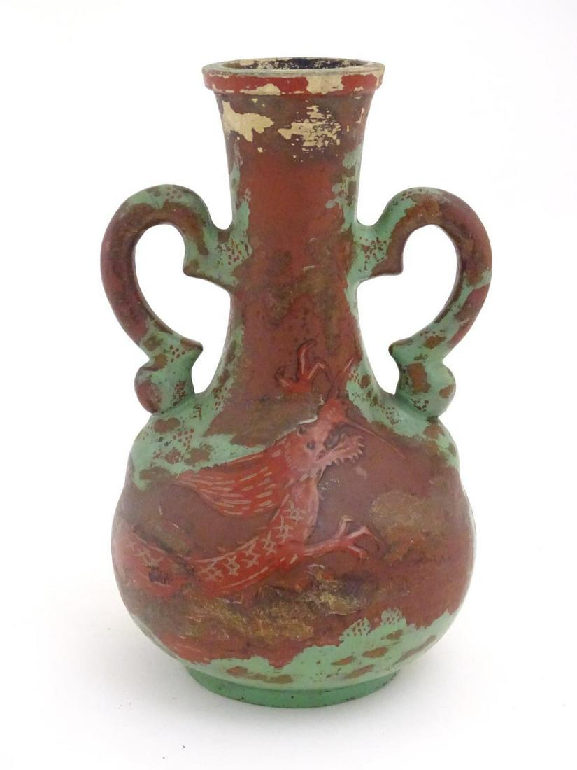 A late 19th / early 20thC bottle vase with shaped twin: A late 19th / early 20thC bottle vase with shaped twin handles, and dragon decoration. Approx. 9" high