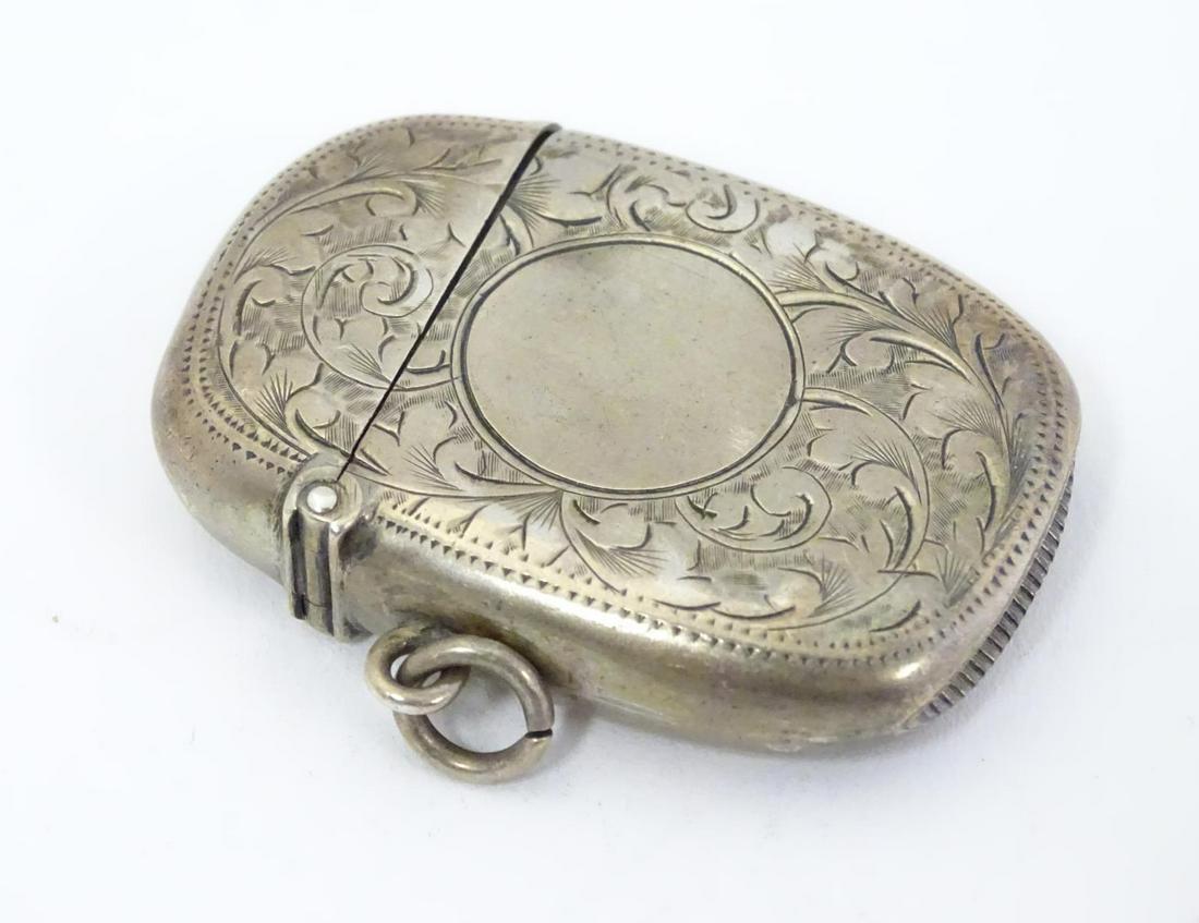 A silver vesta case with engraved decoration maker: A silver vesta case with engraved decoration maker Birmingham 1907 maker William M Hayes. 1 3/4" high