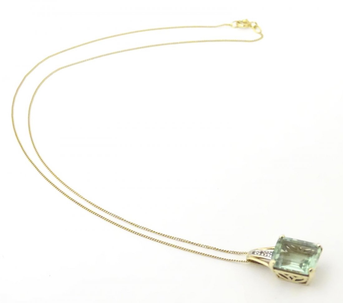 A 9ct gold pendant set with pale green spinel and (1 of 8)
