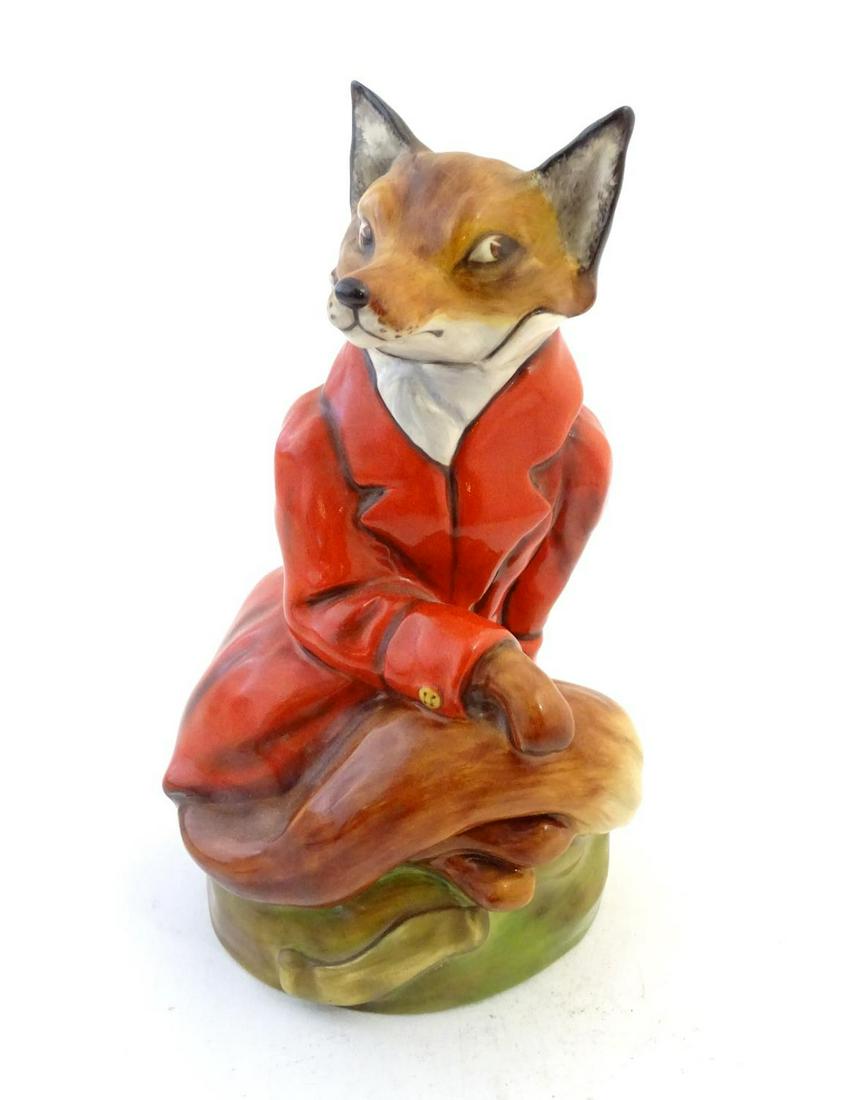 An Ashley limited edition model of a fox wearing a red: An Ashley limited edition model of a fox wearing a red hunting jacket from The Staffordshire Figurine Collection. Marked under, M.B, no. 345 / 2500. Approx. 8" high Category Ceramics