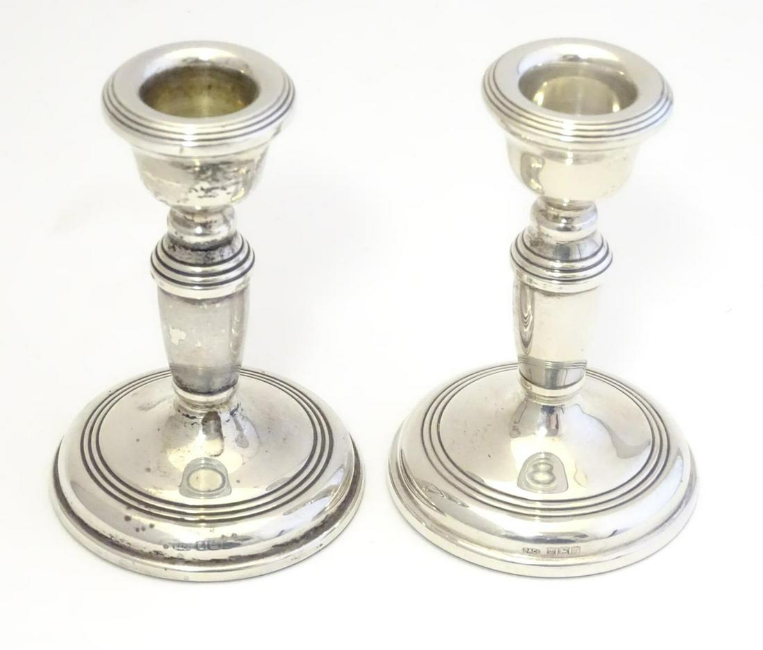 A pair of silver candlesticks with weighted bases. (1 of 6)