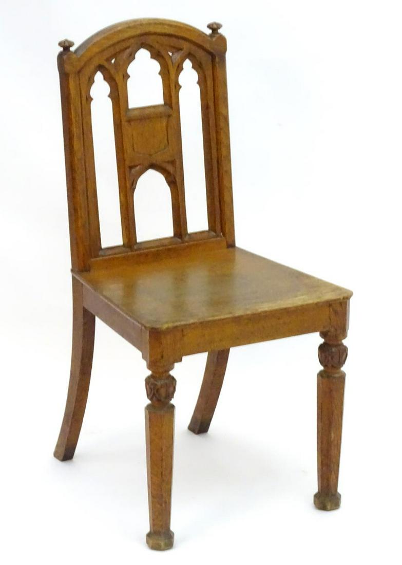 A mid / late 19thC Gothic revival hall chair with a (1 of 3)