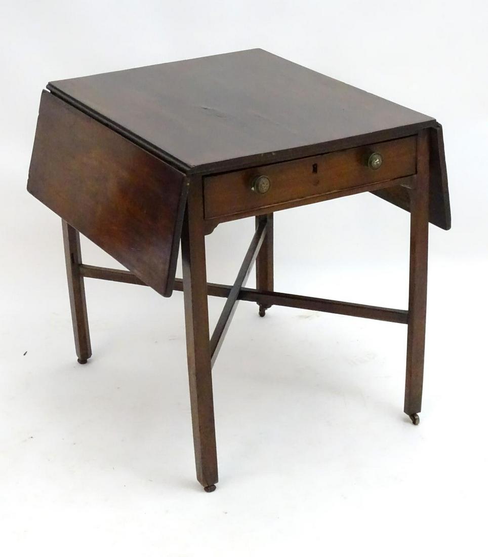 An early 19thC mahogany Pembroke table with two drop: An early 19thC mahogany Pembroke table with two drop flaps to each side and having a single short drawer to one end, raised on squared legs united by a cross stretcher. 28" long x 23" wide x 28" high.