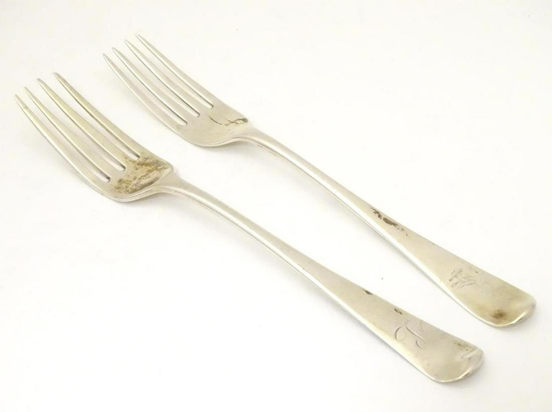 Two Geo III silver forks, hallmarked London 1804 maker: Two Geo III silver forks, hallmarked London 1804 maker Solomon Hougham, and London 1805 maker Christopher & Thomas Wilkes Barker Approx. 7 3/4" long (2)
