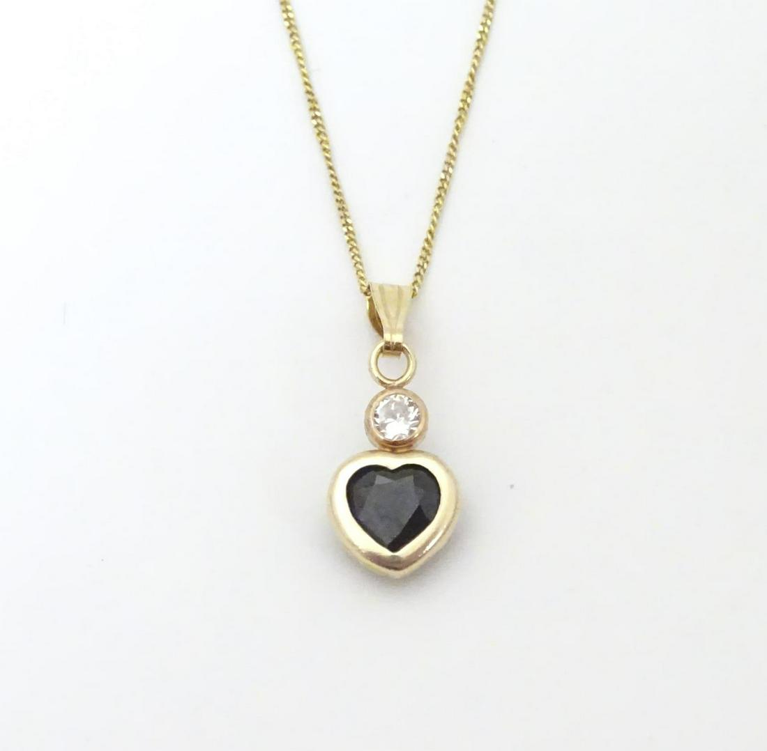 A 9ct gold pendant of heart form set with sapphire and (1 of 6)