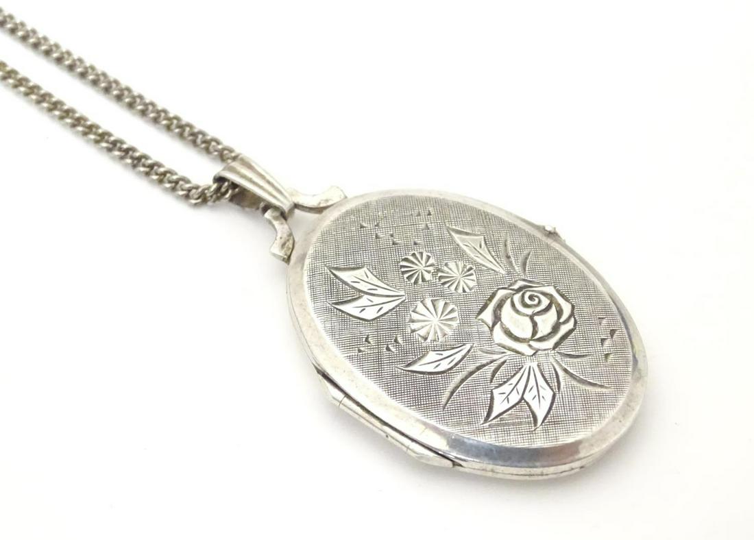 A silver and white metal locket and chain. Approx. 25": A silver and white metal locket and chain. Approx. 25" long overall