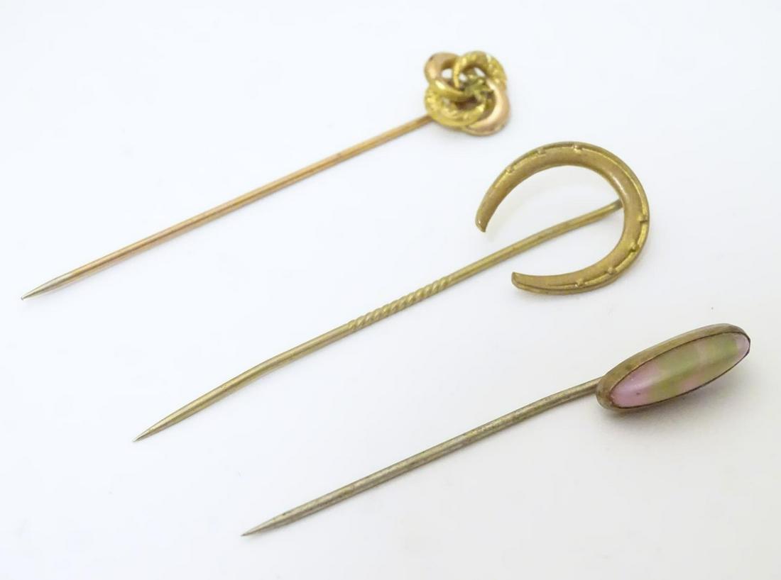 Three assorted gilt metal stick pins, one surmounted by (1 of 3)