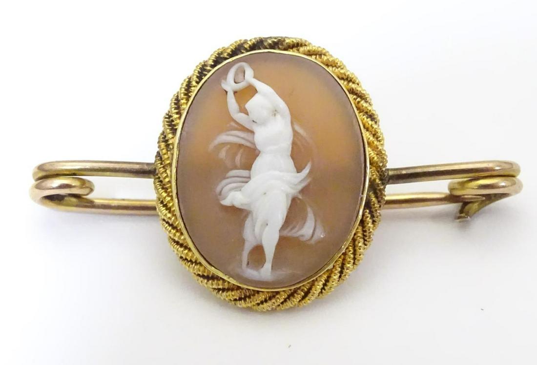 A yellow metal bar brooch set with shell carved cameo. (1 of 6)