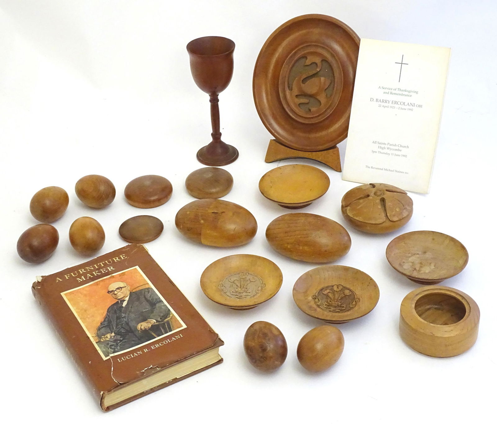 Ercol : A quantity of assorted treen turned wooden: Ercol : A quantity of assorted treen turned wooden items to include models of eggs, roundel with floral motif, dishes with Prince of Wales insignia, an oval plaque with swan detail etc. Some with appl