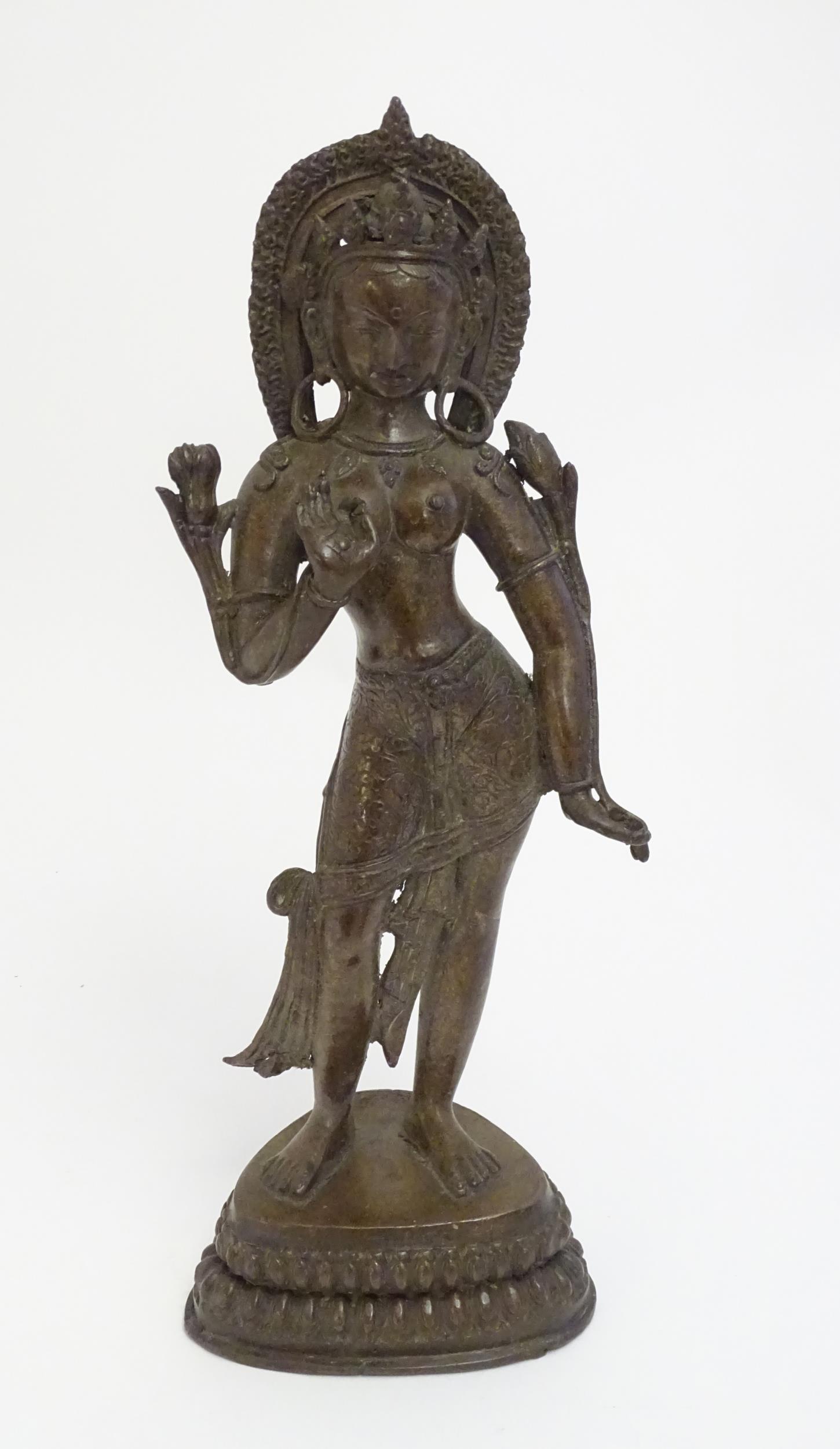 An Indian cast bronze model of a standing deity figure, (1 of 7)