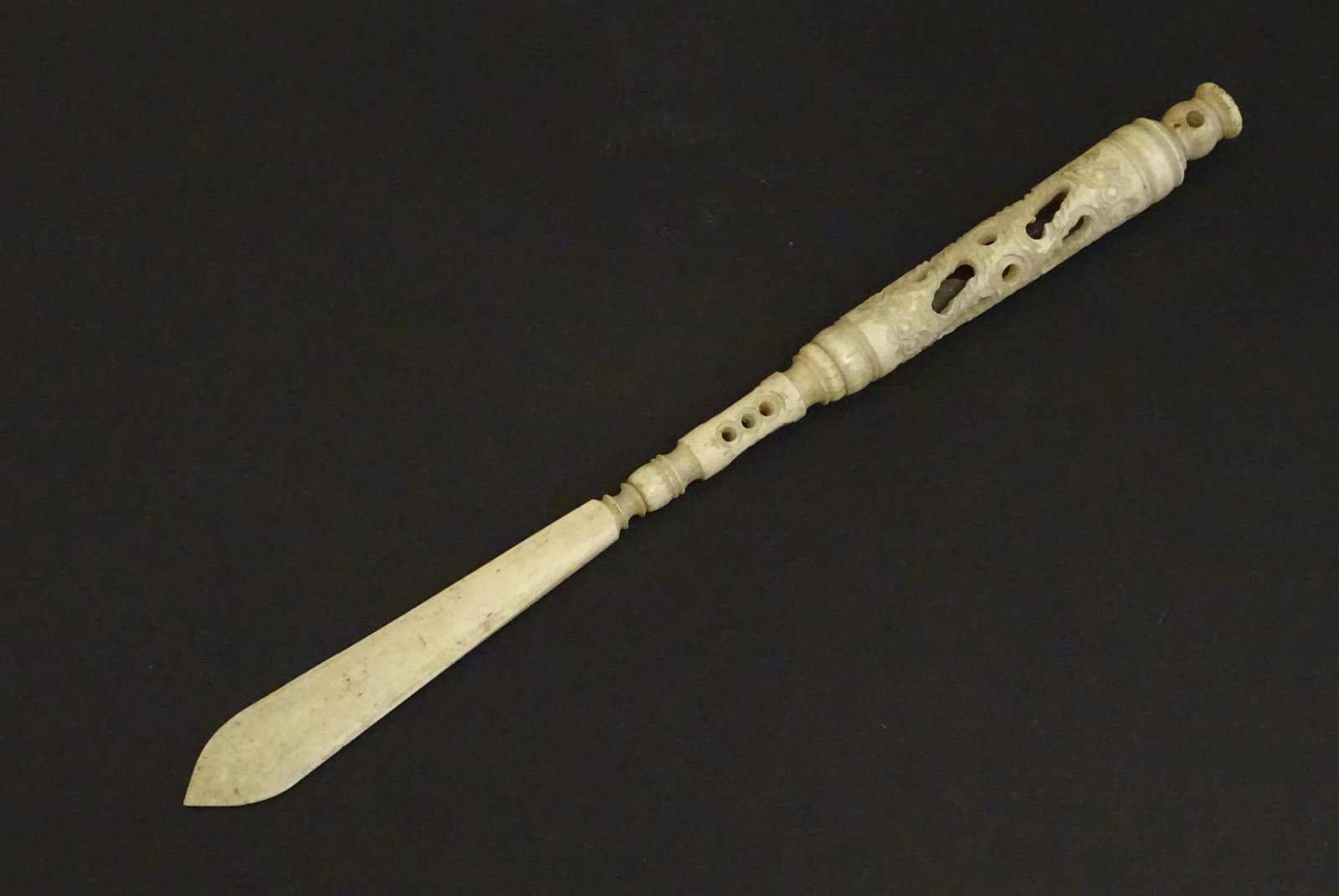 A Victorian bone letter opener / pen / stanhope with: A Victorian bone letter opener / pen / stanhope with carved and pierced detail, the stanhope depicting Crystal Palace. Approx. 8 1/4" overall