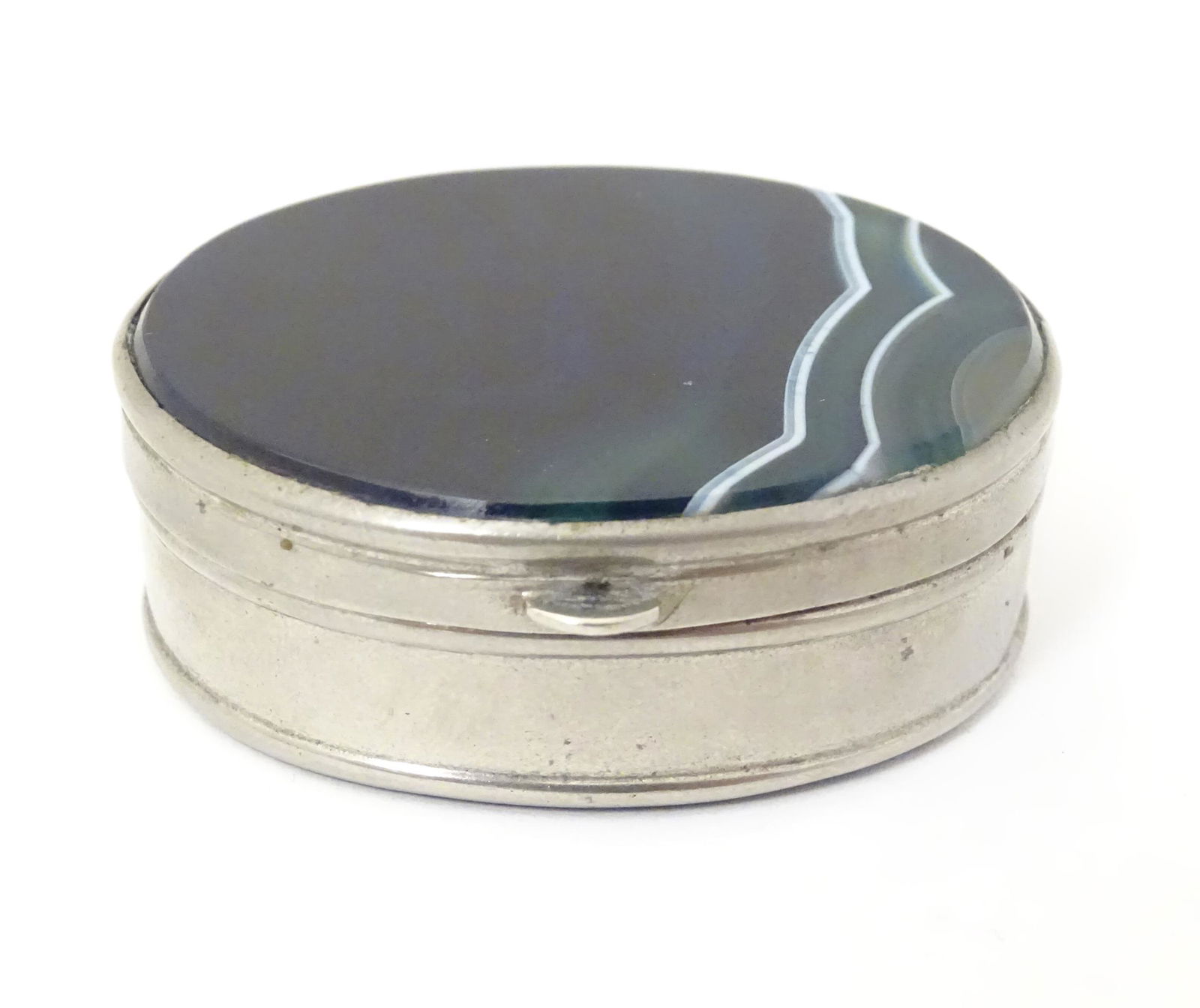 A silver plate pill box of oval form set with blue (1 of 7)