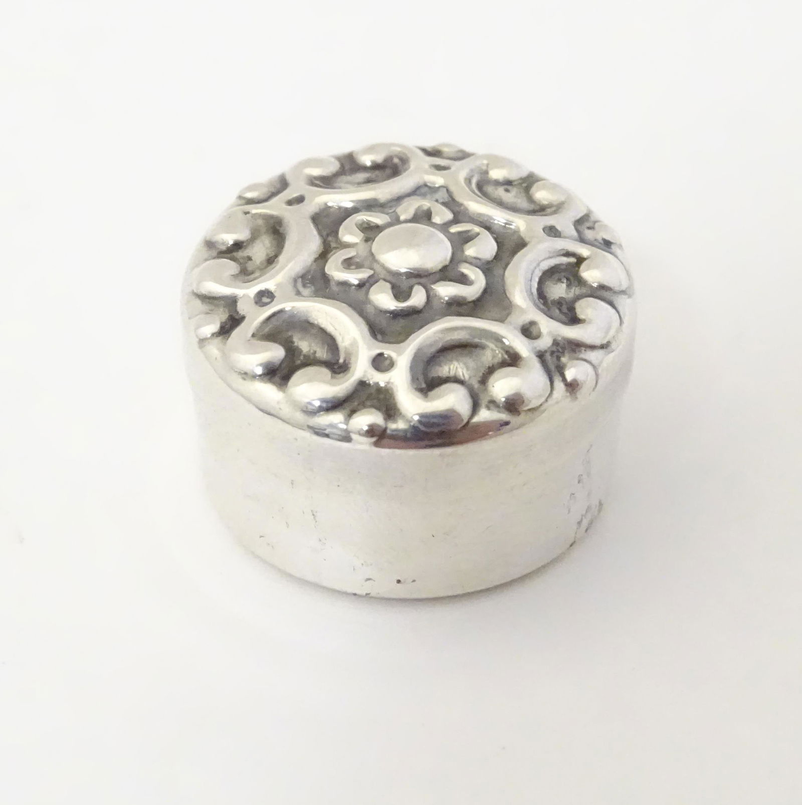 A Spanish silver pill box with C-scroll detail to top.: A Spanish silver pill box with C-scroll detail to top. marked under. Approx 3/4" diameter