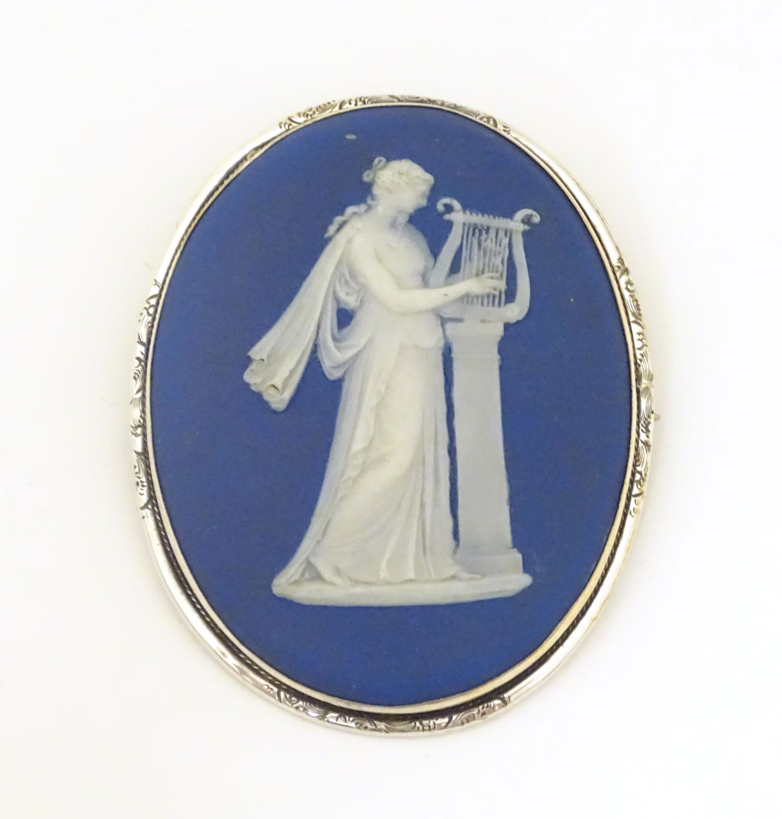 A Wedgwood jasperware brooch of oval form depicting a (1 of 7)