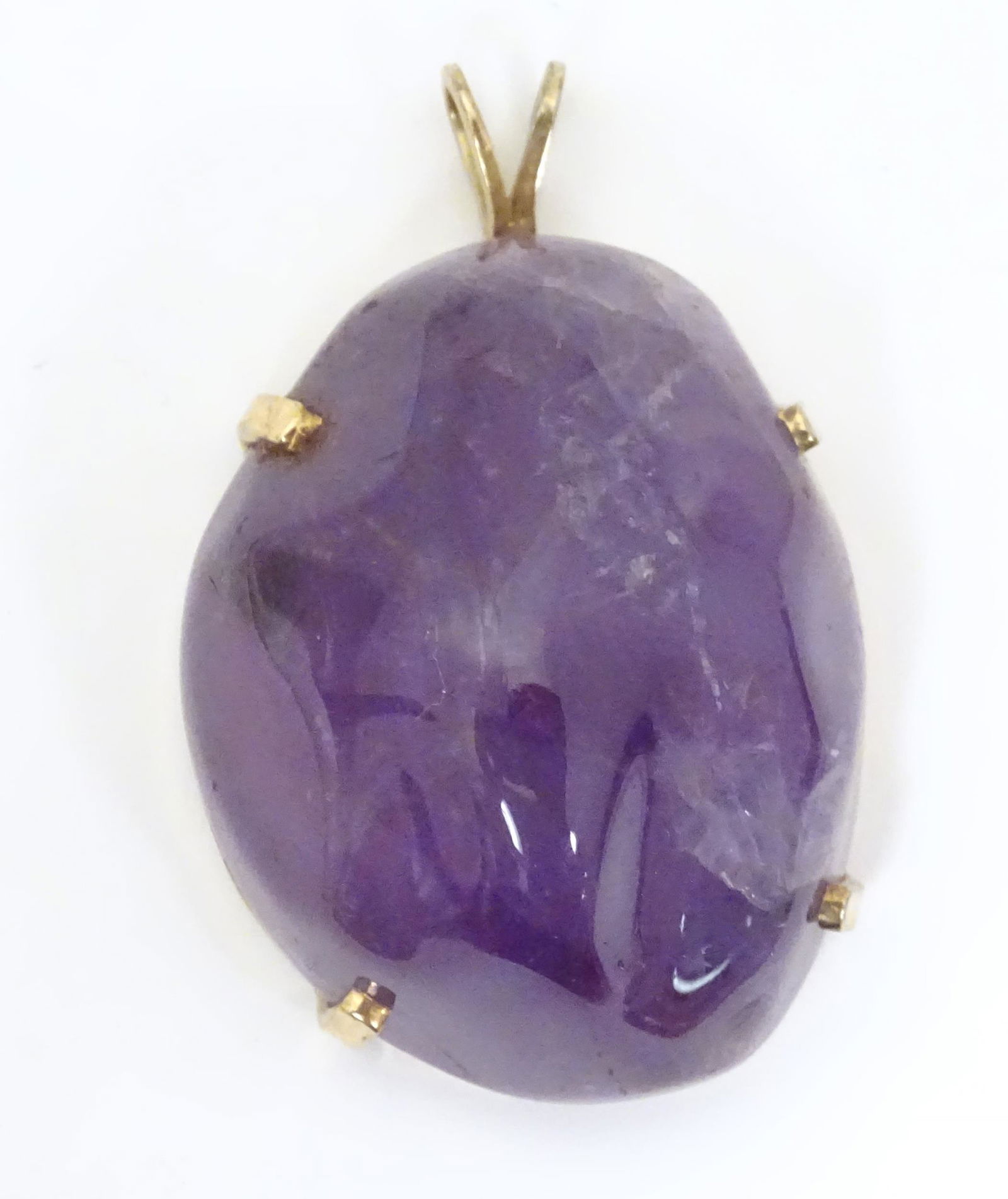 A 14ct gold pendant set with amethyst 1 3/4" long. (1 of 8)