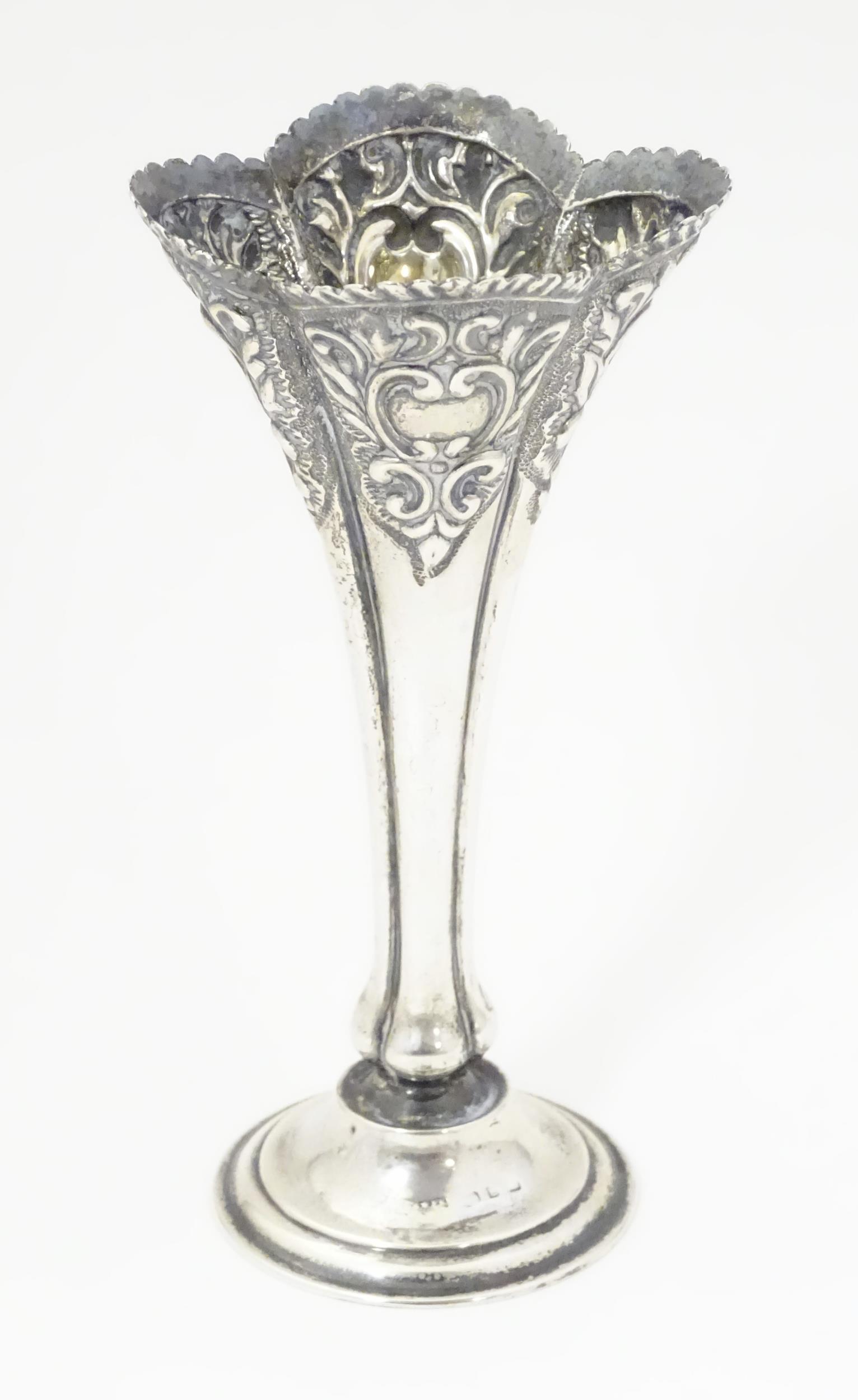 A Victorian silver bud vase with embossed C scroll (1 of 7)