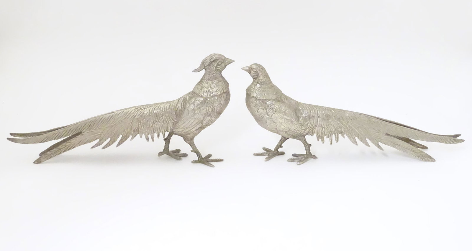 A pair of cast metal table menu holders formed as: A pair of cast metal table menu holders formed as pheasants. Approx 12" long