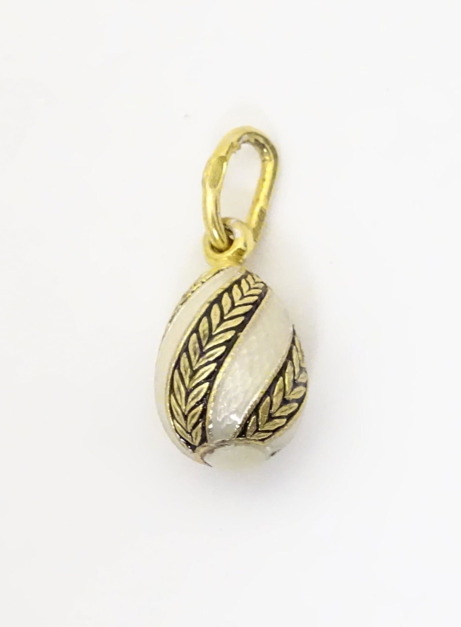 A silver gilt pendant of egg form with enamel: A silver gilt pendant of egg form with enamel decoration. Approx 1/2" long