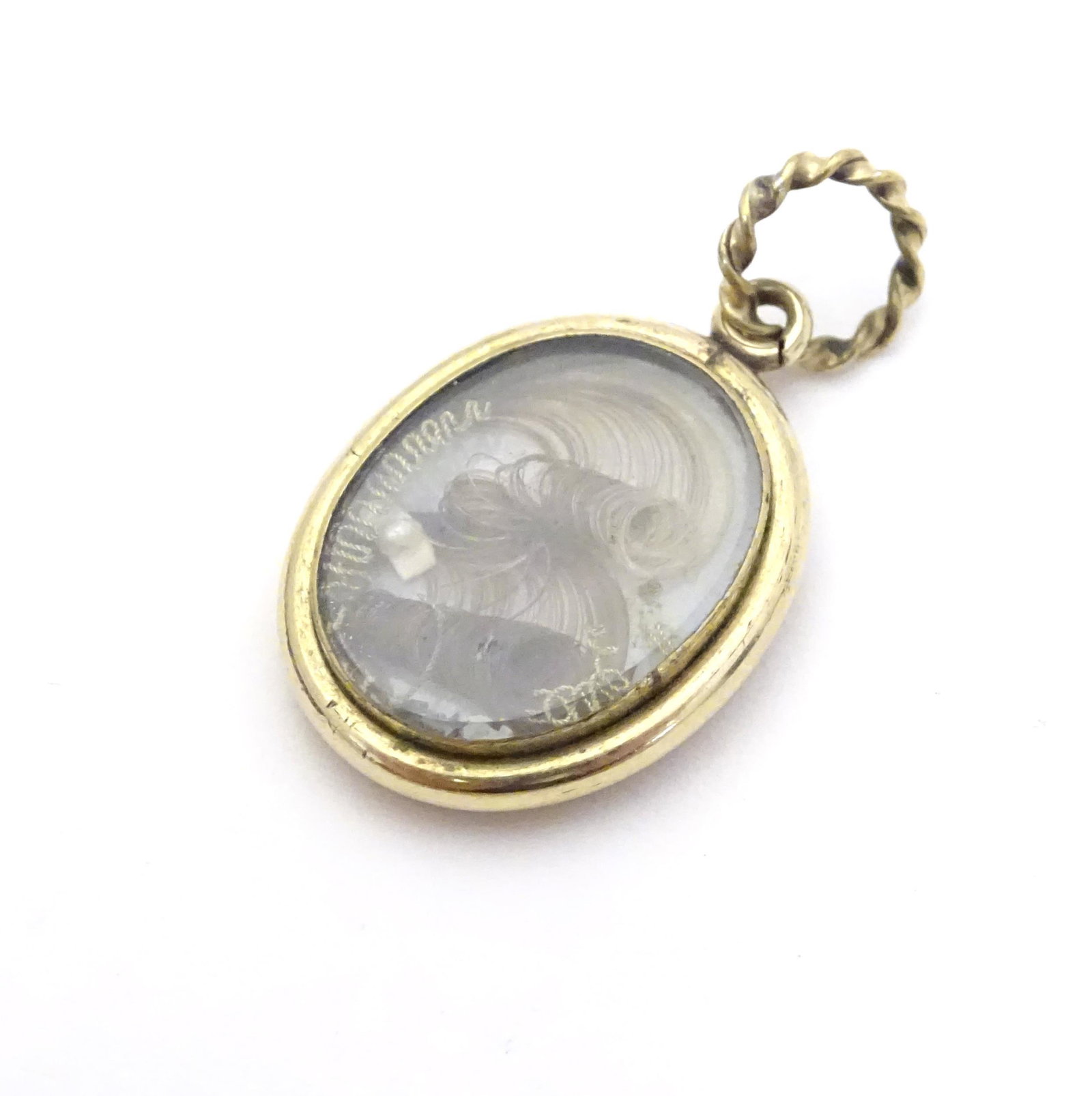 Mourning / Memorial jewellery : A 19thC yellow metal: Mourning / Memorial jewellery : A 19thC yellow metal locket with blue enamel detail to one side, the other set with lock of hair. Approx 1 1/4" long