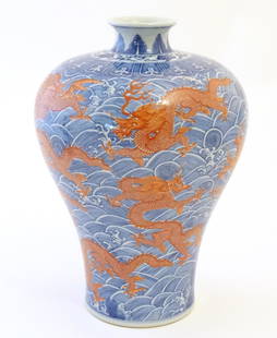 A Chinese Meiping style vase decorated with red dragons amongst stylised waves. Character marks: A Chinese Meiping style vase decorated with red dragons amongst stylised waves. Character marks under. Approx. 13 1/2" high