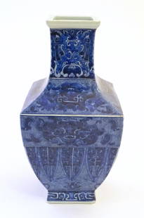 A Chinese blue and white vase of squared form decorated with stylised masks, banded detail and: A Chinese blue and white vase of squared form decorated with stylised masks, banded detail and scrolling foliage. Character marks under. Approx. 14" high