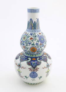 A Chinese double gourd vase with doucai style decoration with scrolling floral and foliate detail.: A Chinese double gourd vase with doucai style decoration with scrolling floral and foliate detail. Character marks under. Approx. 12 1/2" high