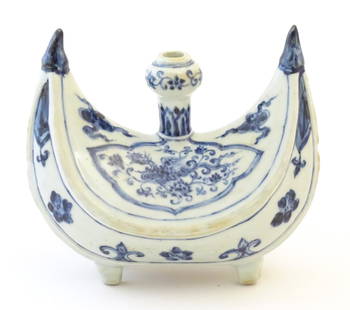 A Chinese blue and white pilgrim's flask of crescent form decorated with a stylised phoenix bird,: A Chinese blue and white pilgrim's flask of crescent form decorated with a stylised phoenix bird, clouds, flowers and foliage. Approx. 7 1/4" high x 8" wide